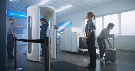 Airport Security Check: Diverse Passengers Passing Through Metal Detector Scanner, Taking Suitcases...