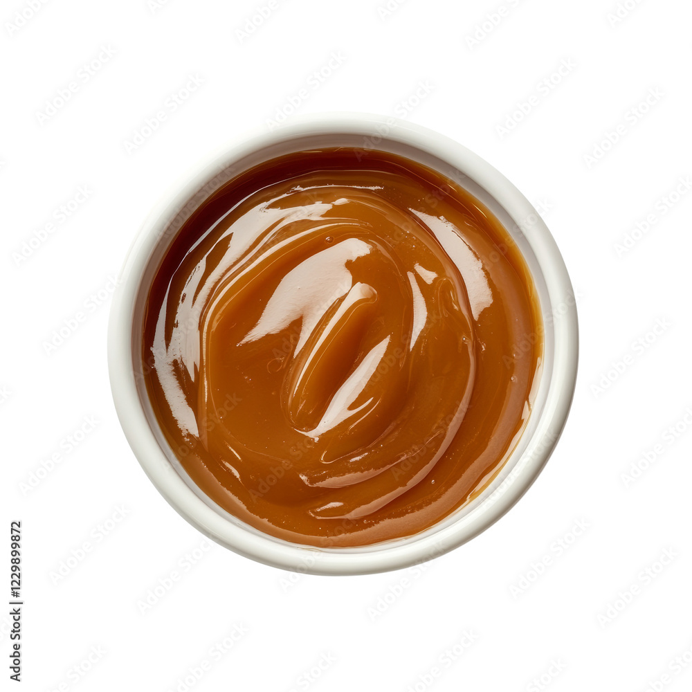 Poster a top view of a small white bowl filled with a glossy swirl of caramel sauce.