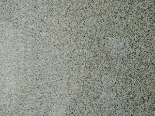 close-up view of a granite surface. The granite has a speckled pattern with various shades of gray and black.