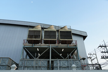 Air compressor or air condenser unit located on support outside building to heat released...