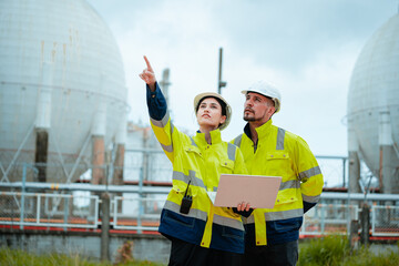 Workers evaluate operations at an industrial facility while discussing safety protocols