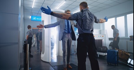 Airport Security Check: Mature Man Passes Through Metal Detector Scanner, Takes Bag from Conveyor...