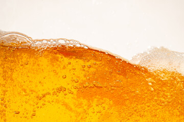 Close up bright orange Oil or beer splash texture and nature waves, Beautiful waves curve and little bubbles smooth for graphic design and background, Oil Bubbles, Soft beer bubbles, Selective focus
