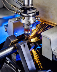 machine in action for laser cutting of metal tube