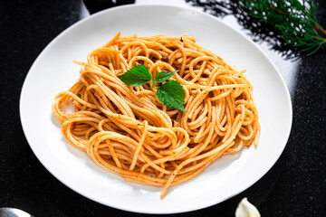 Spicy Spaghetti on dark table with high angle 
