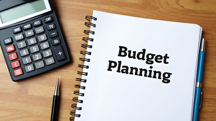 A notebook with the words budget planning is open on a wooden table beside a calculator and a pen, emphasizing financial organization and management