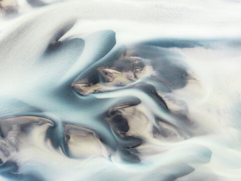 Abstract patterns in a river from a glacier.
