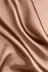 Silk fabric in mocha mousse shade, closeup. Trendy color of 2025 year