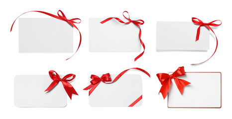 Blank cards with red bows isolated on white, top view