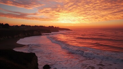 Obraz premium A breathtaking view of a huge wave rolling toward the beach at sunset.