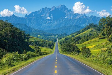 Naklejka premium Mountain road through green valley landscape, perfect for travel or adventure ads