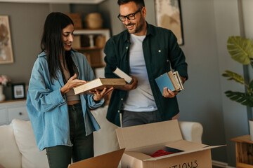 Young adults analyzing books and discussing thoughts in their stylish living room