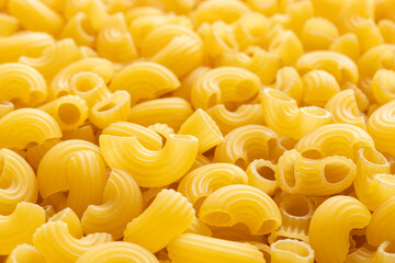 Heap of raw elbow macaroni. Close-up