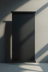 Black roll up banner on a grey background with light