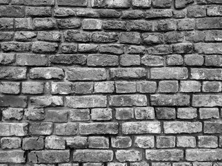 Black Brick Wall with Dark Stone Texture and Overhead Lighting Effect
