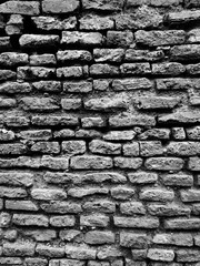 Black Brick Wall with Dark Stone Texture and Overhead Lighting Effect