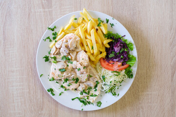 Creamy mushroom chicken breast with fries and salad