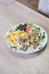 Creamy mushroom chicken with fries and salad