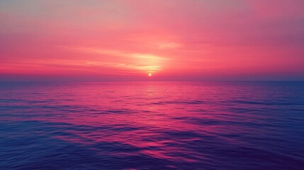 Fototapeta premium Pink sunset over calm ocean waters. Serene and beautiful.