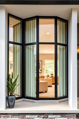 Modern Home Interior Design: A Captivating View Through a Chic Bay Window. The architectural details and the interior's soft light create a serene atmosphere.