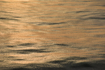 Calm sea surface. Sunshine glow.