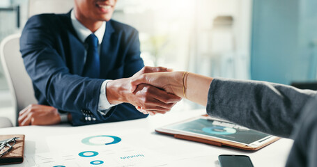 Handshake, meeting and business people in office with statistics for collaboration, partnership and thank you. Graphs, finance company and worker with boss for project approval, research and success © KayJoint/peopleimages.com