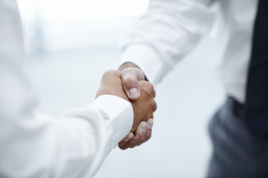 Closeup, meeting and business people with handshake for agreement, introduction and corporate deal. Office, employees and accountants with shaking hands for welcome, partnership and teamwork for b2b