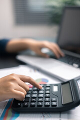 Finance bank tax expense accounting budget money businessman hand use calculator Financial calculate accountant close up calculator with graph chart write office desk Business expense analysis saving
