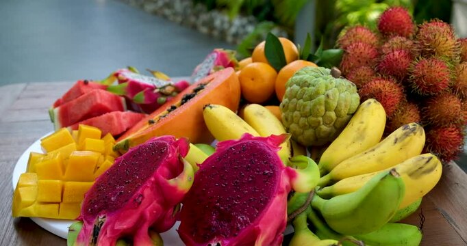 Thai Fresh Exotic Fruits (Pineapple, Coconut, Mango, Rambutan, Masngosteen, Dragon Fruit, Rose Apple, Sugar Apple, Snake Fruit) on the Table. Healthy Vitamin Nutritious Food. 