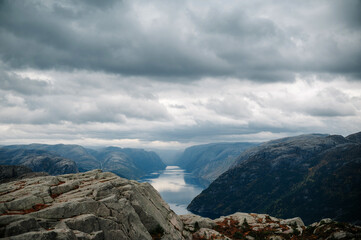 Scenic Fjord with Rocky Cliffs and Cloudy Sky