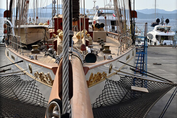 The old-fashioned white sailing vessel with bowsprit and masts in Aganlar Marina and shipyard...