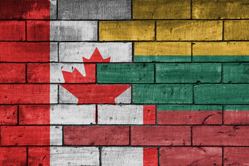 colourful painted big flag of canada and flag of lithuania on a massive old brick wall background....