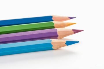 Fototapeta premium several colored pencils are lined up in a row on a white surface