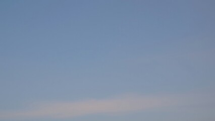 Serene Pale Blue Sky with Wispy Clouds - Peaceful Nature Background