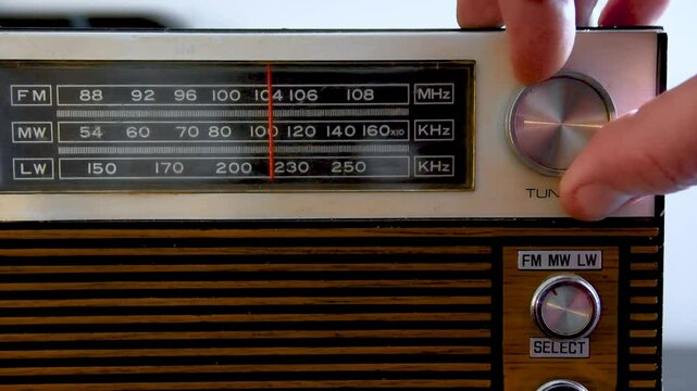 Searching for a radio channel on an old radio from the 70s. Close-up with sound.