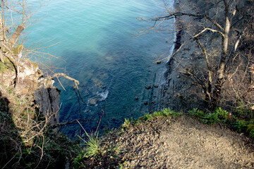 cliff cliff behind which is the blue sea
