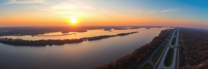 Obraz premium Panoramic view of the Mississippi River at sunset, with the Purple Heart Memorial Highway stretching along its banks, american heartland, sunsets, roadside attractions