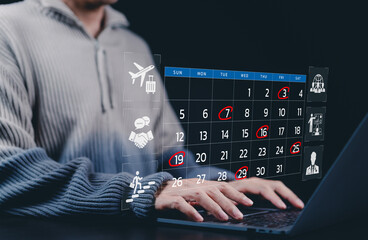 Time management and calendar planning concepts. A person using laptop with a digital calendar...