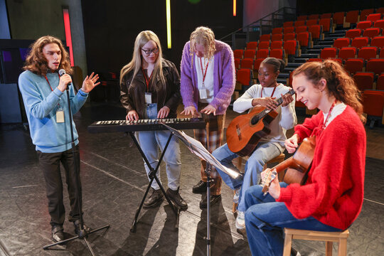 Friends playing and singing during rehearsal - Powered by Adobe