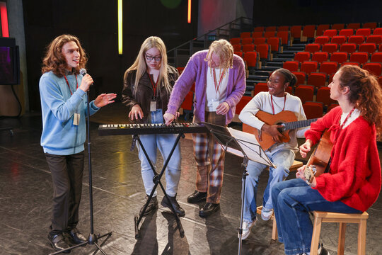 Friends playing and singing during rehearsal - Powered by Adobe