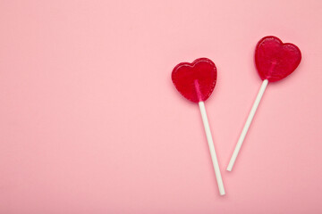 Sweet heart shaped lollipops on pink background. Valentine's day celebration