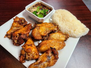 Crispy Thai Chicken Wings with Sticky Rice and Dipping Sauce Eye Level View