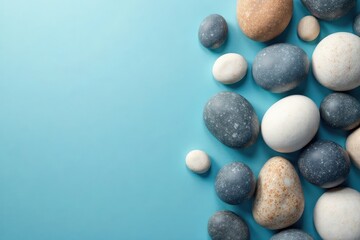 Varied-sized round sea stones on soft blue abstract backdrop, minimal, element, abstract