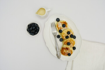 Enjoy Delicious Pancakes with juicy Blueberries and a Creamy Drizzle to elevate breakfast
