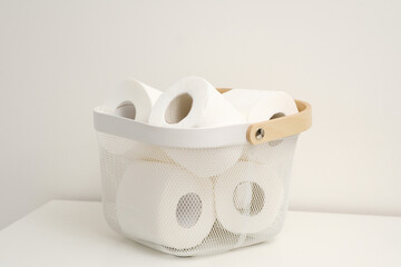 An Organized and Stylish Basket Containing Toilet Paper Rolls for Essential Home Needs
