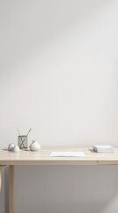 Minimalist photo of a simple wooden desk with a few office supplies scattered around it on a white and gray background, desk, white