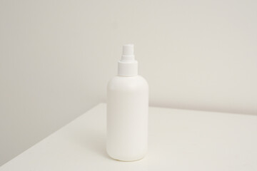 Empty white plastic tubes for cosmetics with towels. Mockup. Packaging for cream, gel, serum, advertising and product promotion