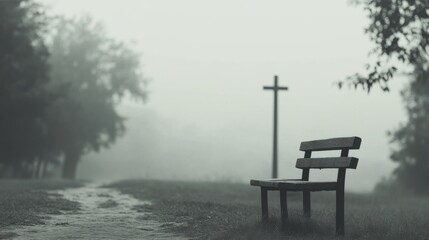 Fototapeta premium Foggy park path, bench, cross.