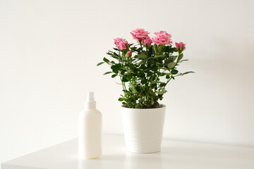 white blank plastic bottle for garden and domestic plant fertilizer on white table.