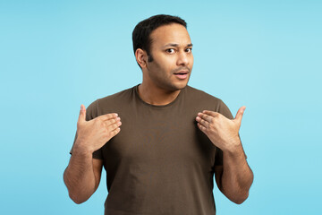 Surprised man pointing himself with open mouth and hands on chest
